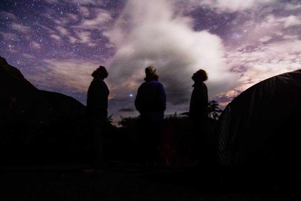 3 guys gaze up into the night sky whilst our new friend teaches us about constellations