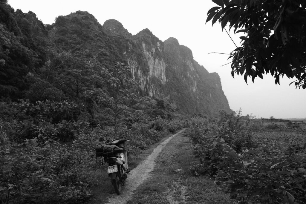 Motorbike perched up alongside Karst Mountains near unknown North village in Vietnam