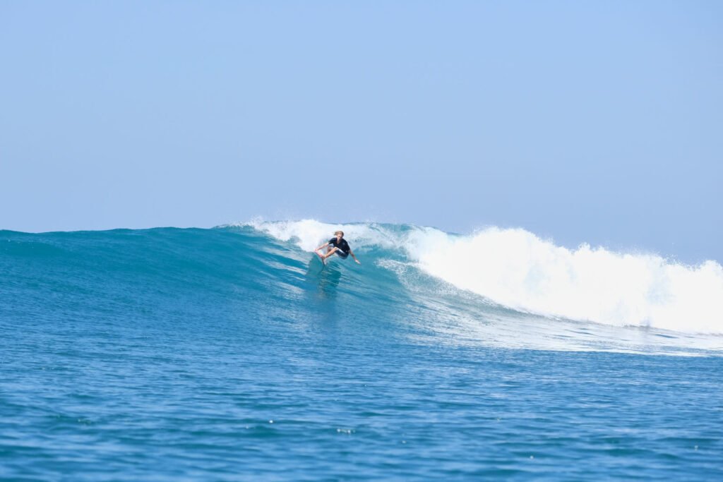 Dylan Price signature grab rail turn on a perfect point break in Indonesia