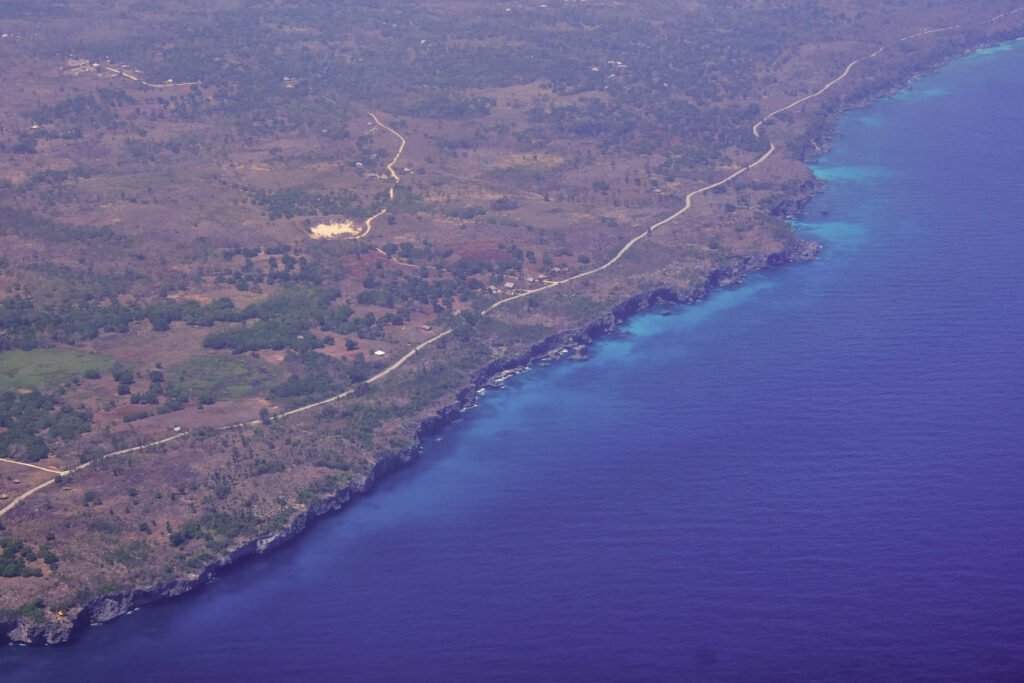 Deep blue hues from the airplane above an island of Indonesia