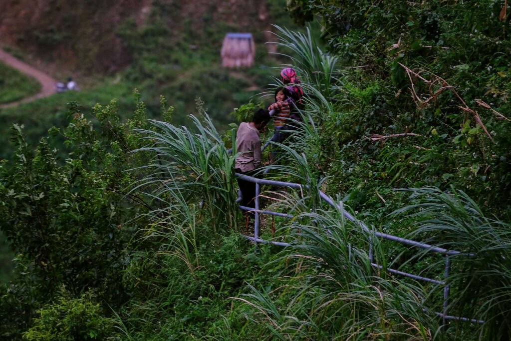 Villagers stop to harvest goods on the side of the sky path