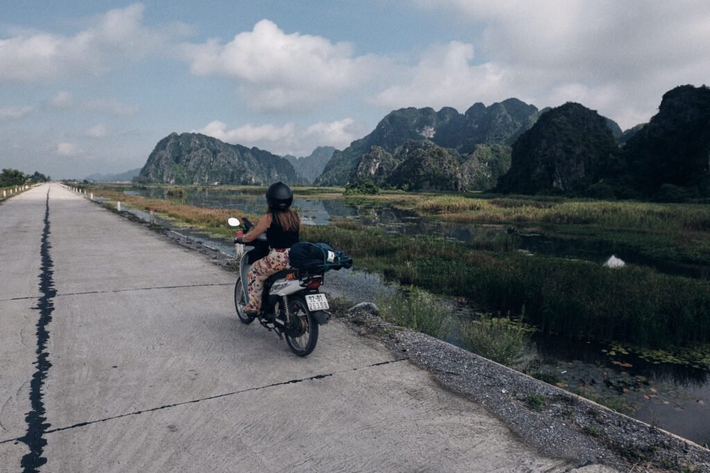 Riding on scooter alongside lake and Karst Mountain system