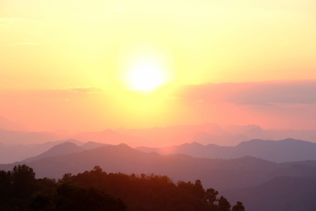 Yellow, orange and red hues flare up around the mountain ranges around Bao Lac