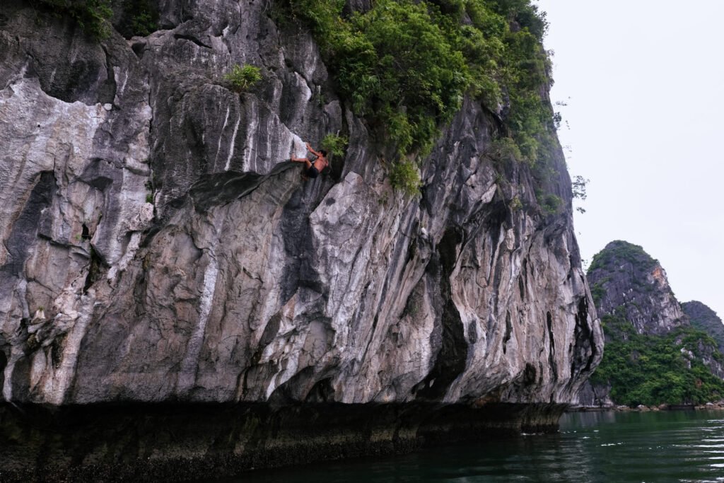 Our tour guide Hai casually climbs a very hard route without shoes or ropes on the island of Cat Ba.