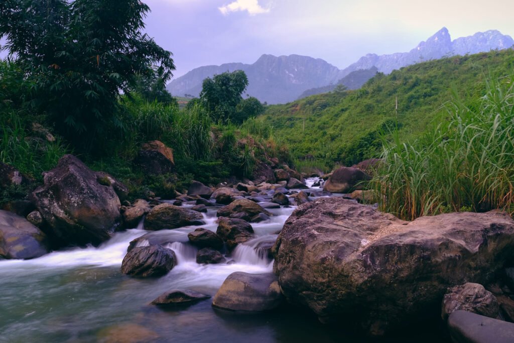 A free flowing clean river at the base of the mountain range in Du Gia, Vietnam