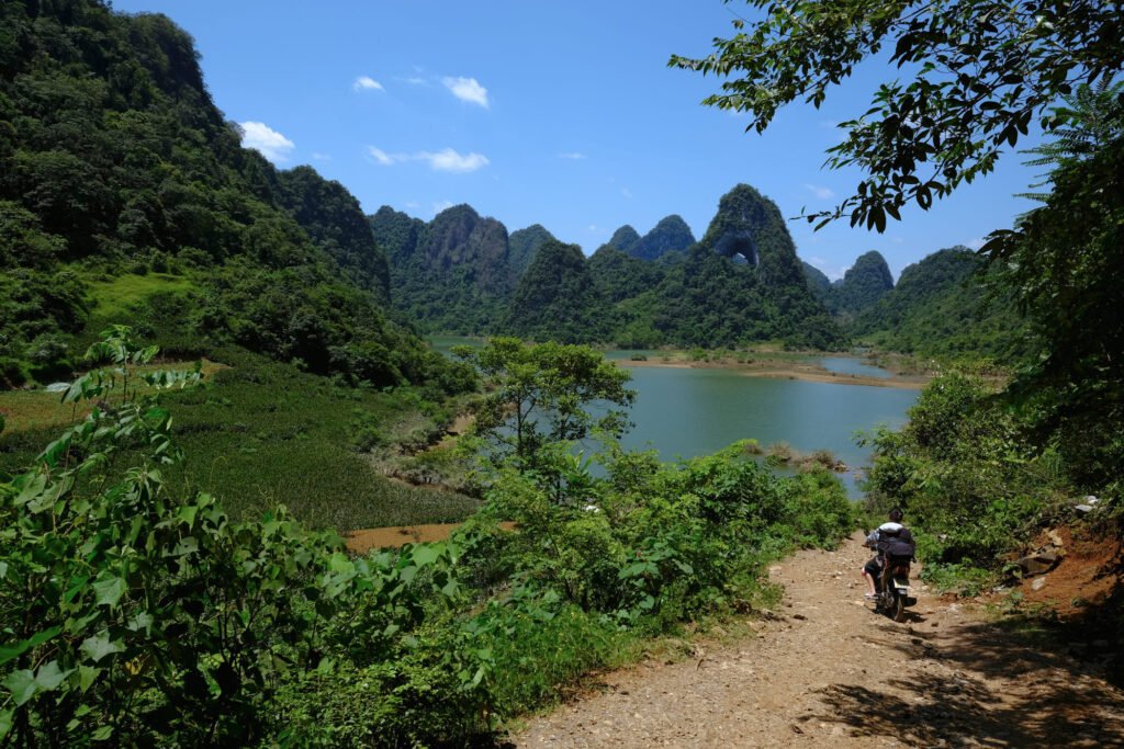 Driving down a steep dirt road on a road bike requires intense concentration, its made all the better with a beautiful lake/mountain background. God's Eye mountain with a whole in the middle of it standing strong in the background.