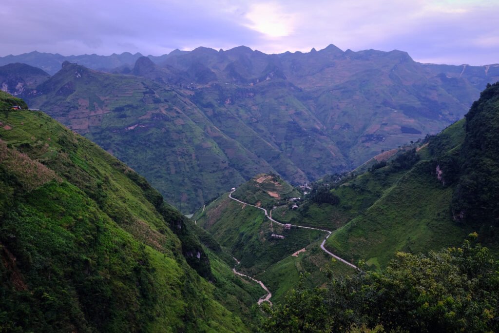 Roads cut and wind down to the base of Tu San Canyon. The ranges loom, making you feel insignificant.