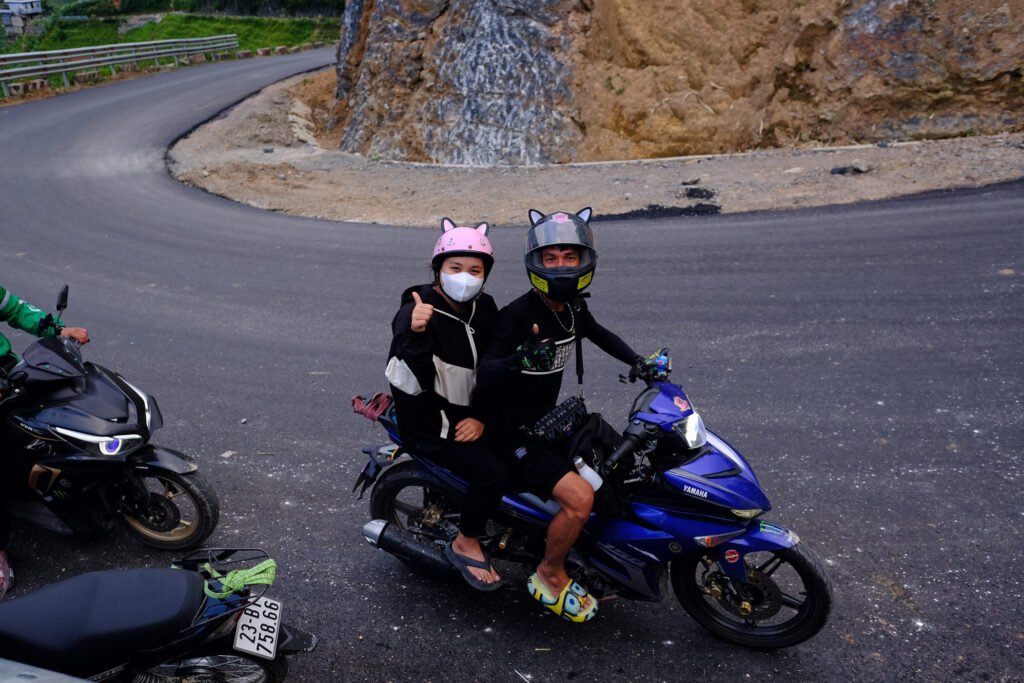 Two Vietnamese people posing for a photo on a motorbike - Ma Pi Leng Pass