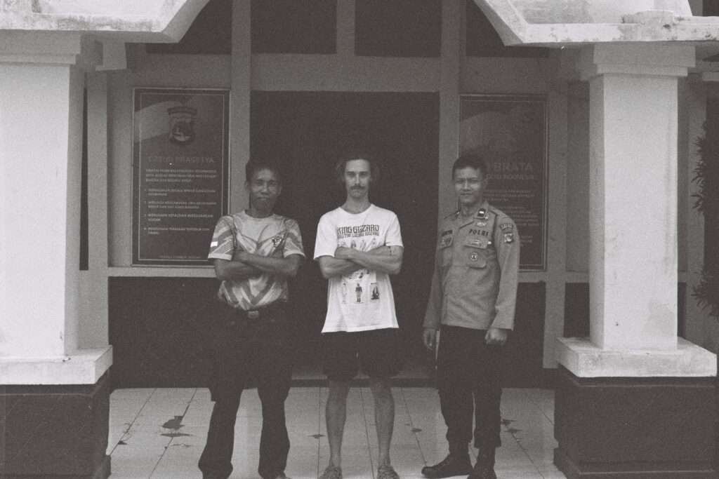 Standing outside of the police station in Lombok with police after filing a report