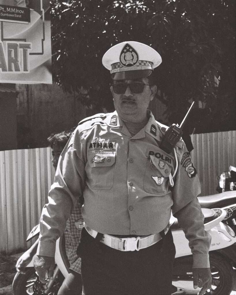 A police officer stands at he directs traffic in Sumbawa